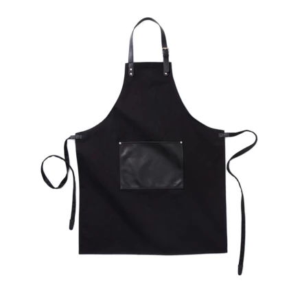 Stylish and classic apron in thick cotton canvas with discreet details in vegan leather. Adjustable buckle closure at the top and large pocket in the front. An apron with a long lifespan that only gets more beautiful with time. (NAX-VG019-03)